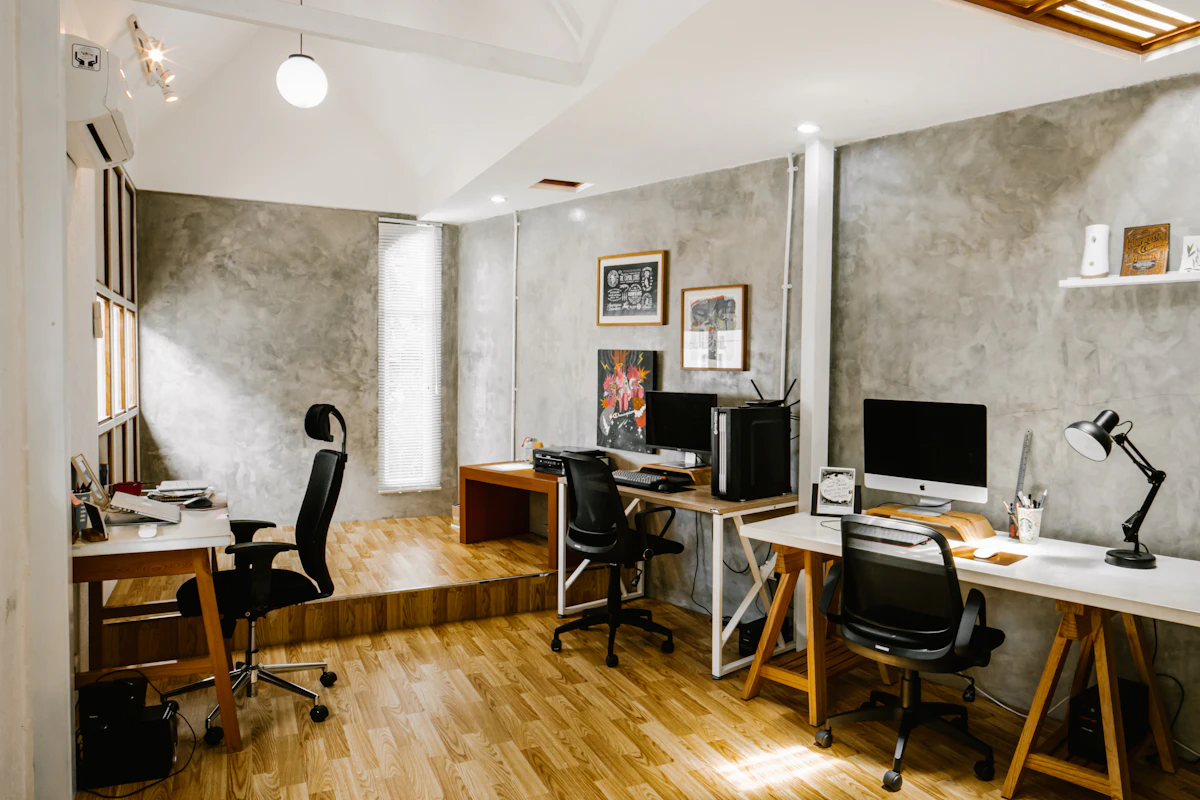 A small office with computer workstations and natural light